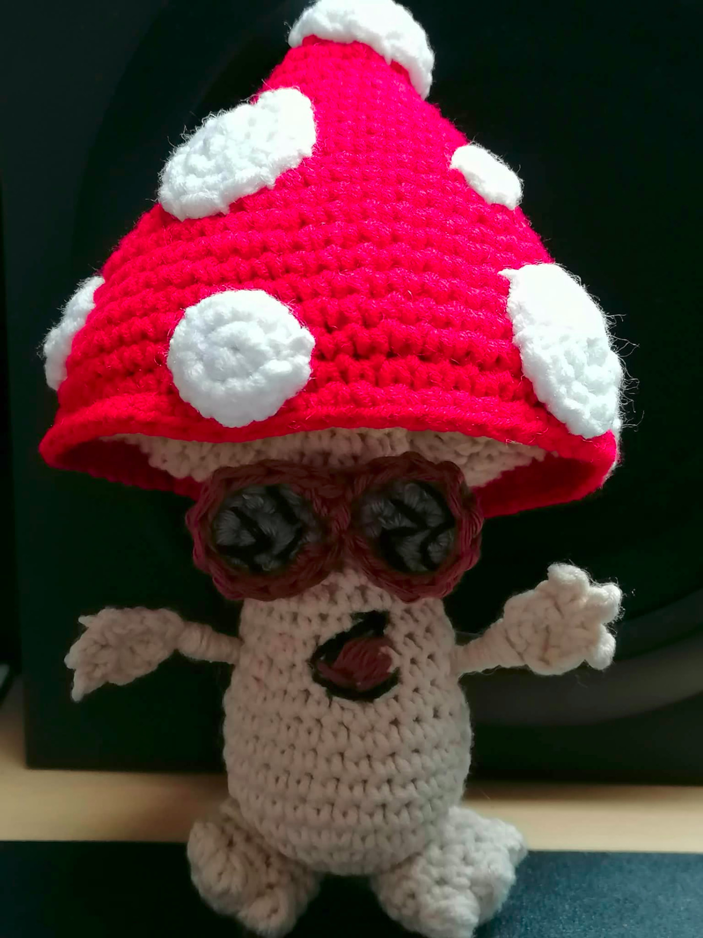 A handmade crocheted woodland character in natural shades