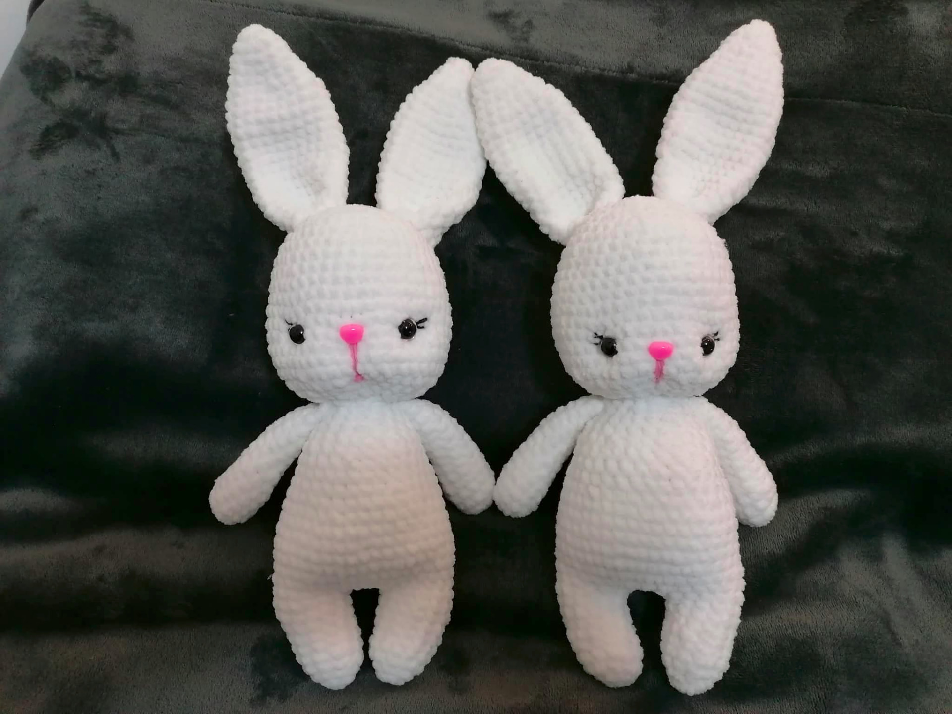 Two small handmade crocheted characters placed together