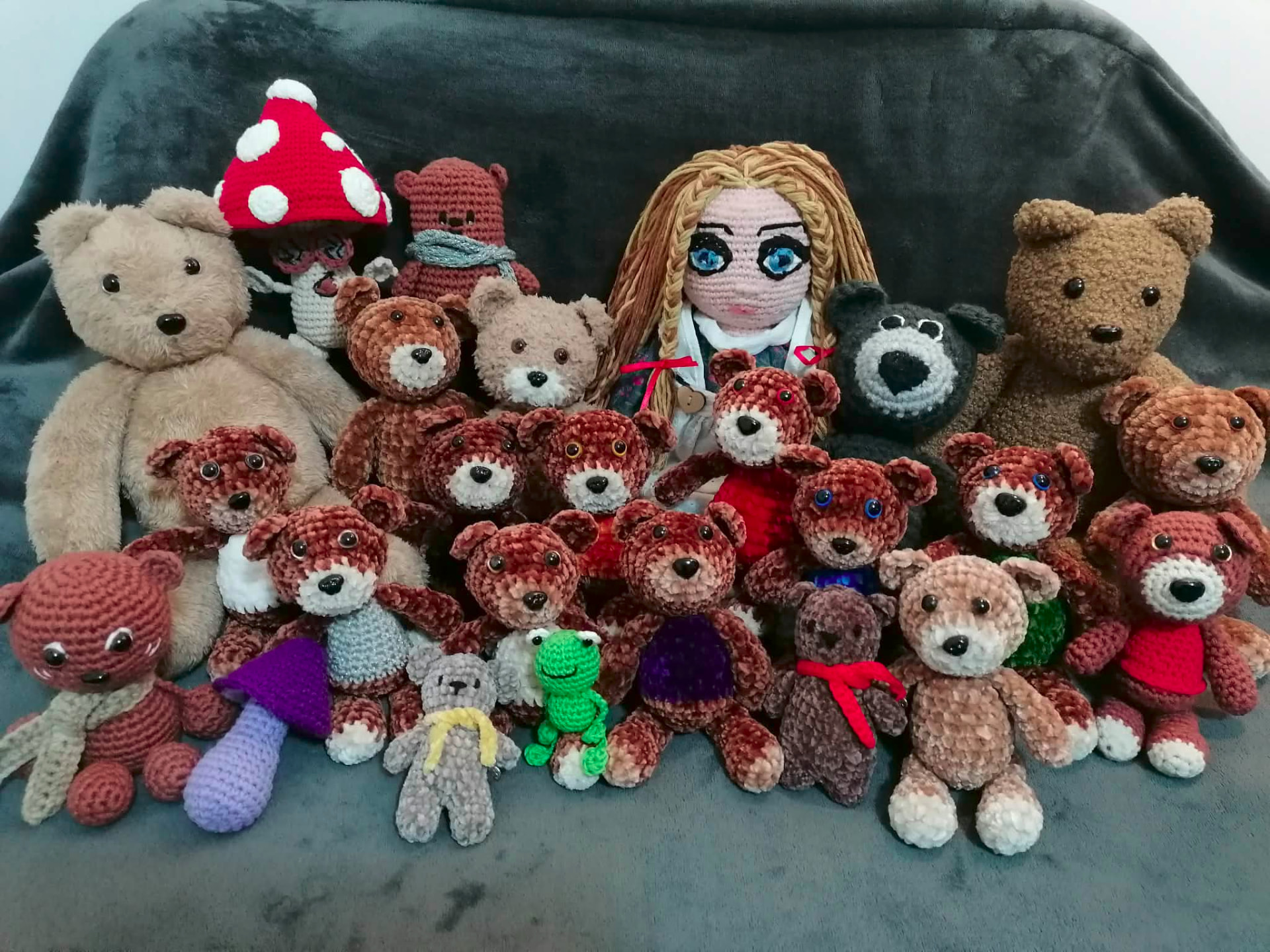 A large group of handmade teddy bears and characters gathered together