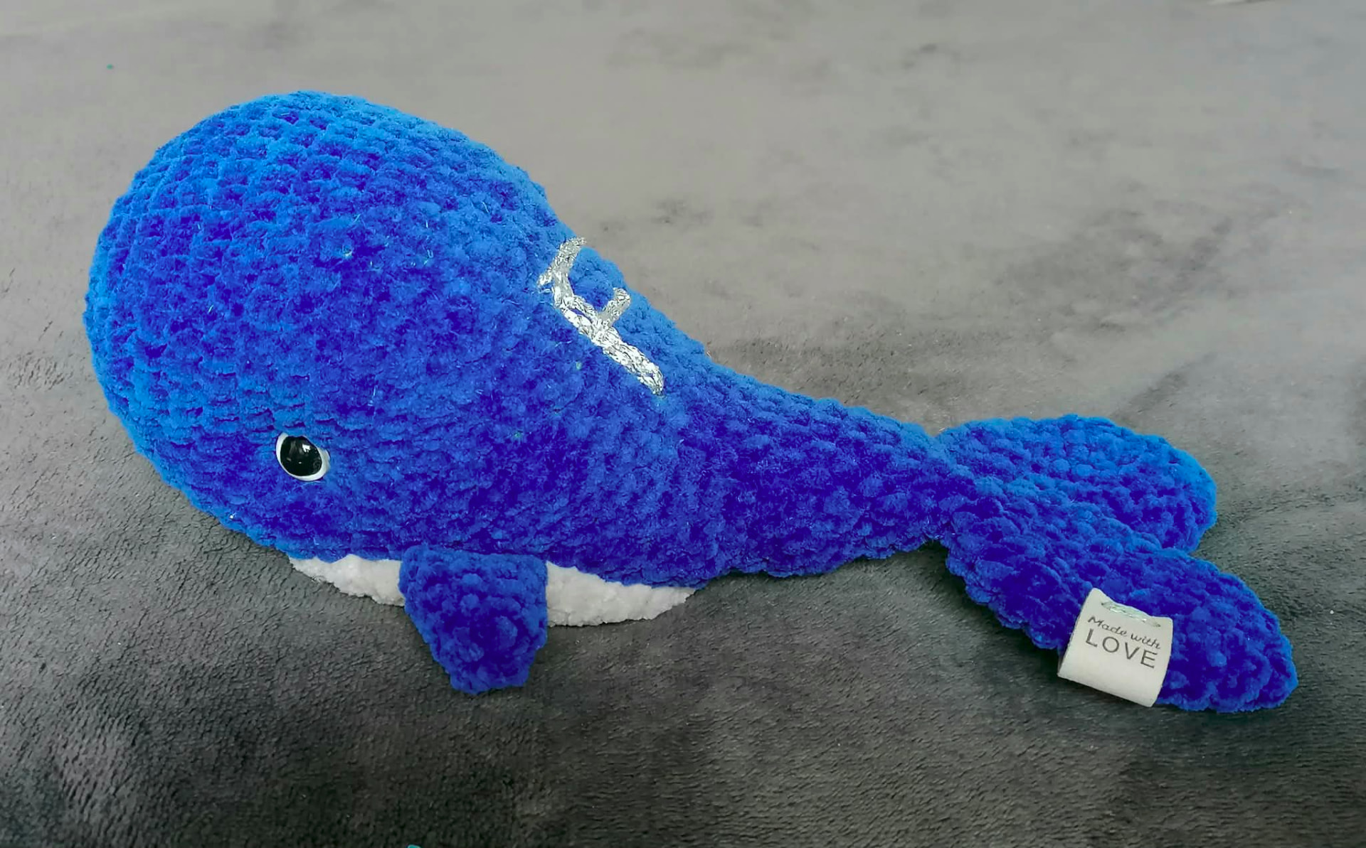 A handmade blue crocheted whale